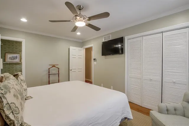 a bedroom with a large bed and a flat screen tv