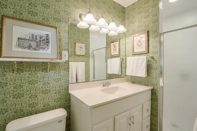 a bathroom with a sink a toilet and a mirror