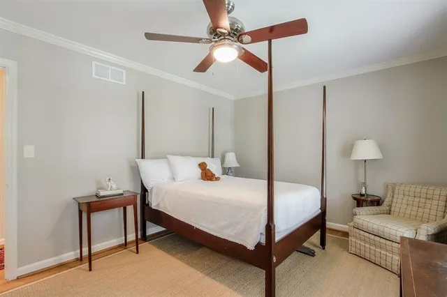 a bedroom with a bed and a lamp