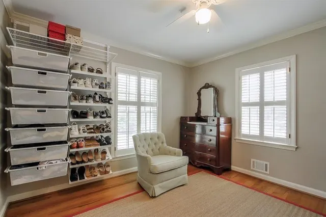 a living room with furniture cabinets and window