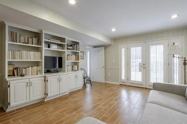 a view of a livingroom with workspace and wooden floor