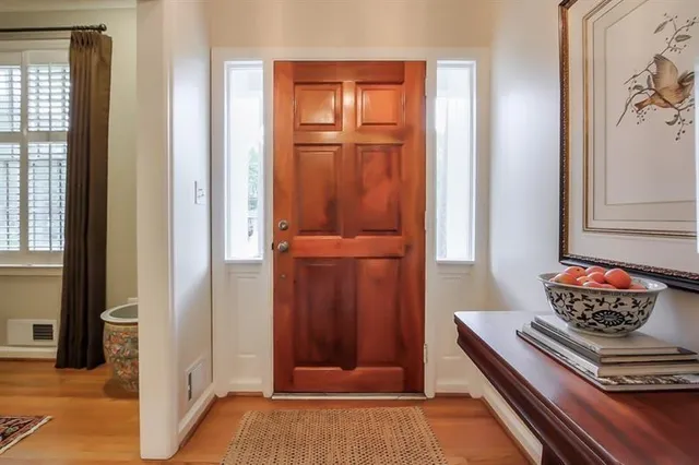 a view of a hallway with wooden floor and front door