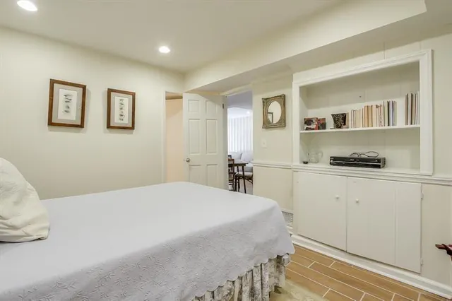 a spacious bedroom with a bed and a cabinets