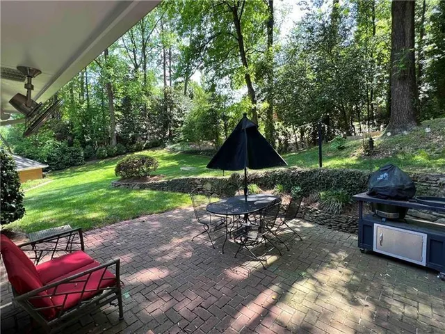 a view of a backyard with sitting area