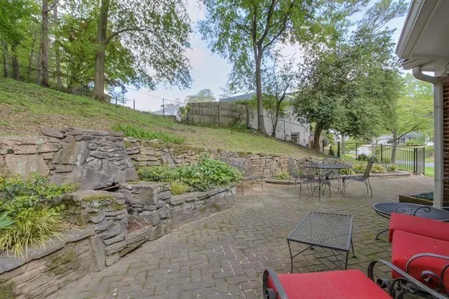 a view of backyard with outdoor seating and green space