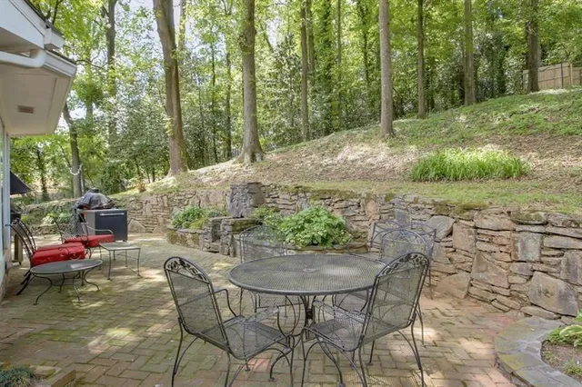 a view of backyard with table and chairs and couches