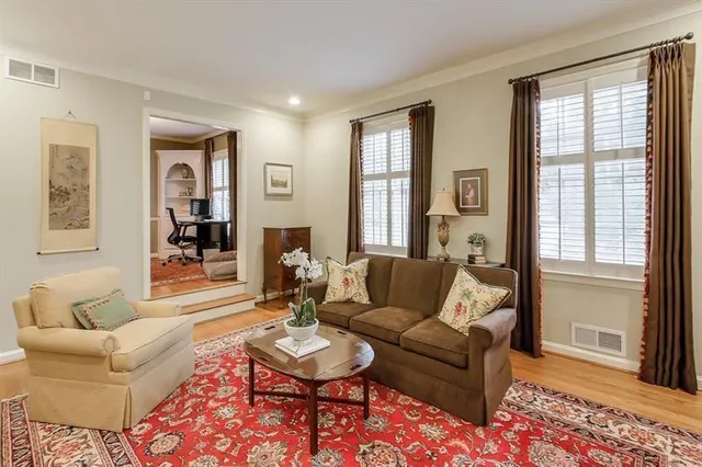 a living room with furniture and wooden floor