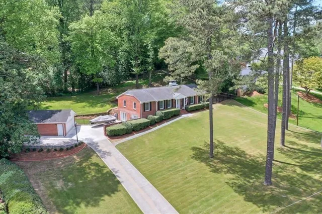 swimming pool view with a garden view