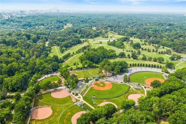 an aerial view of a swimming pool a yard and green space