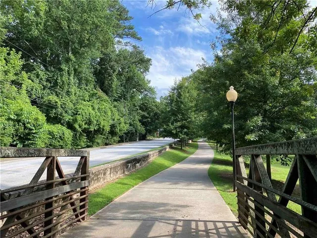 a view of a swimming pool with a patio and fire pit