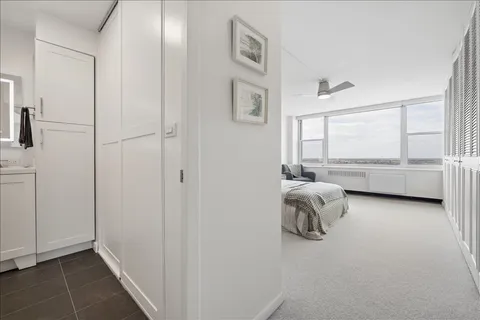 a spacious bedroom with a bed and a large window