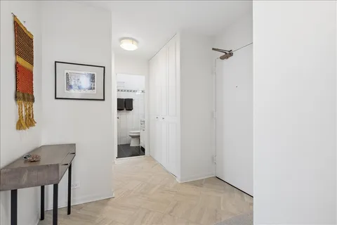 a bathroom with a toilet a sink and a mirror