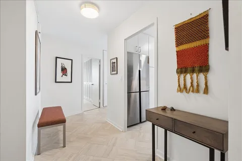 a view of a workspace with furniture and a window