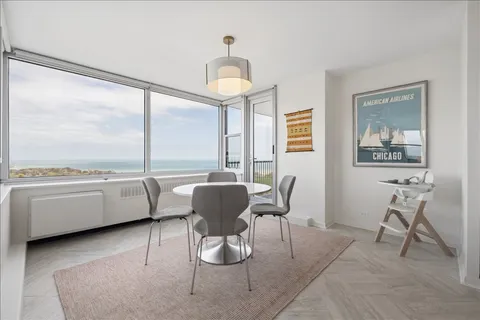 a living room with stainless steel appliances furniture a dining table and chairs