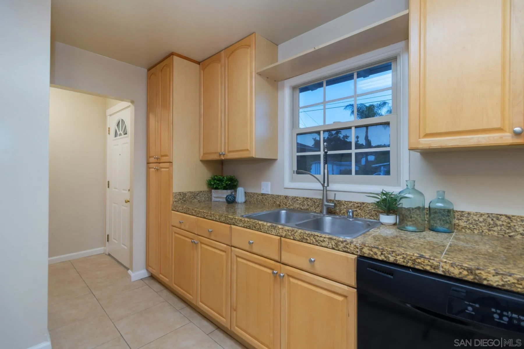 13424 Powers Road Poway, CA 92064 - Photo 11 of 24 a kitchen with granite countertop a sink stainless steel appliances white cabinets and a window