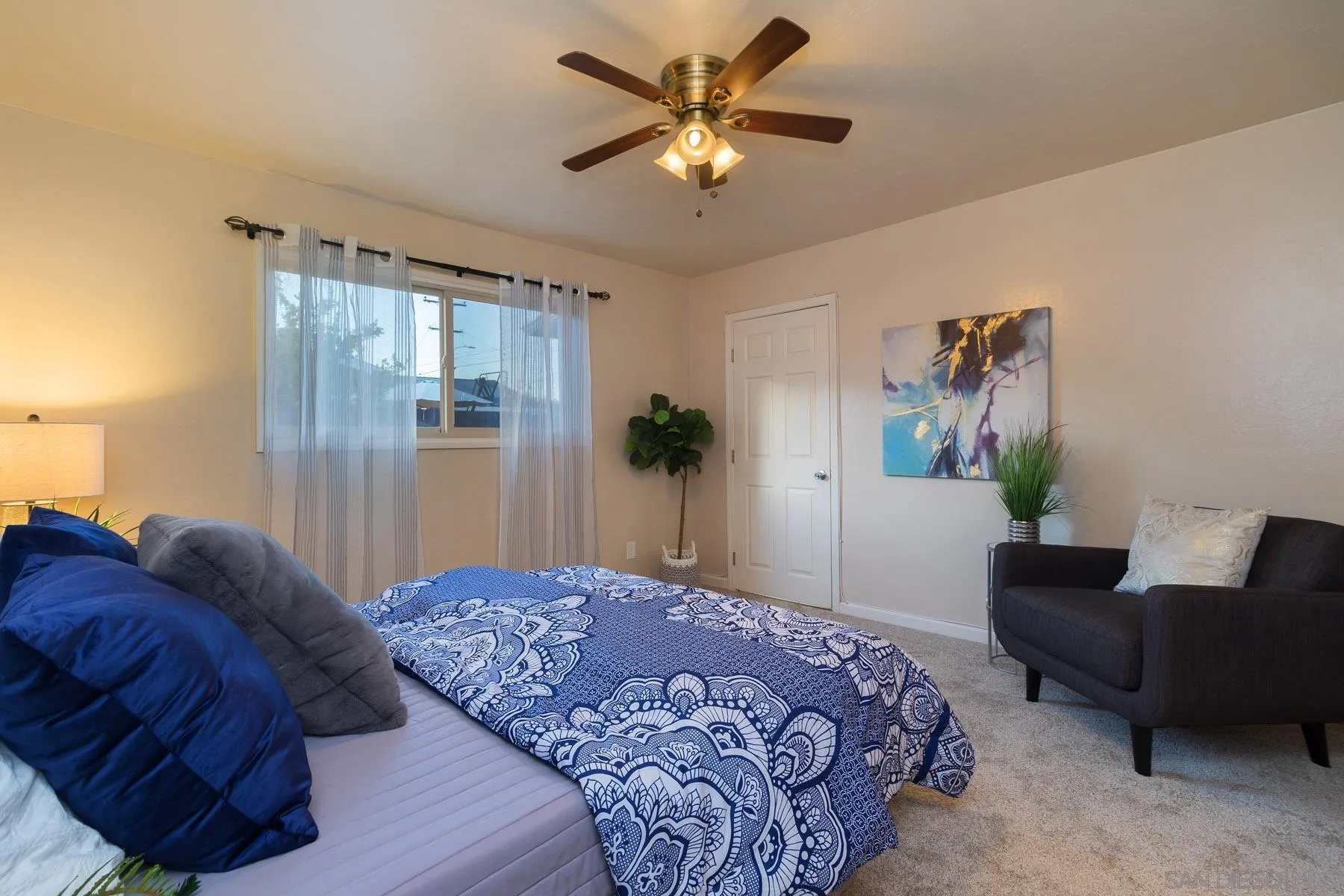 13424 Powers Road Poway, CA 92064 - Photo 12 of 24 a bedroom with a bed couch and a potted plant