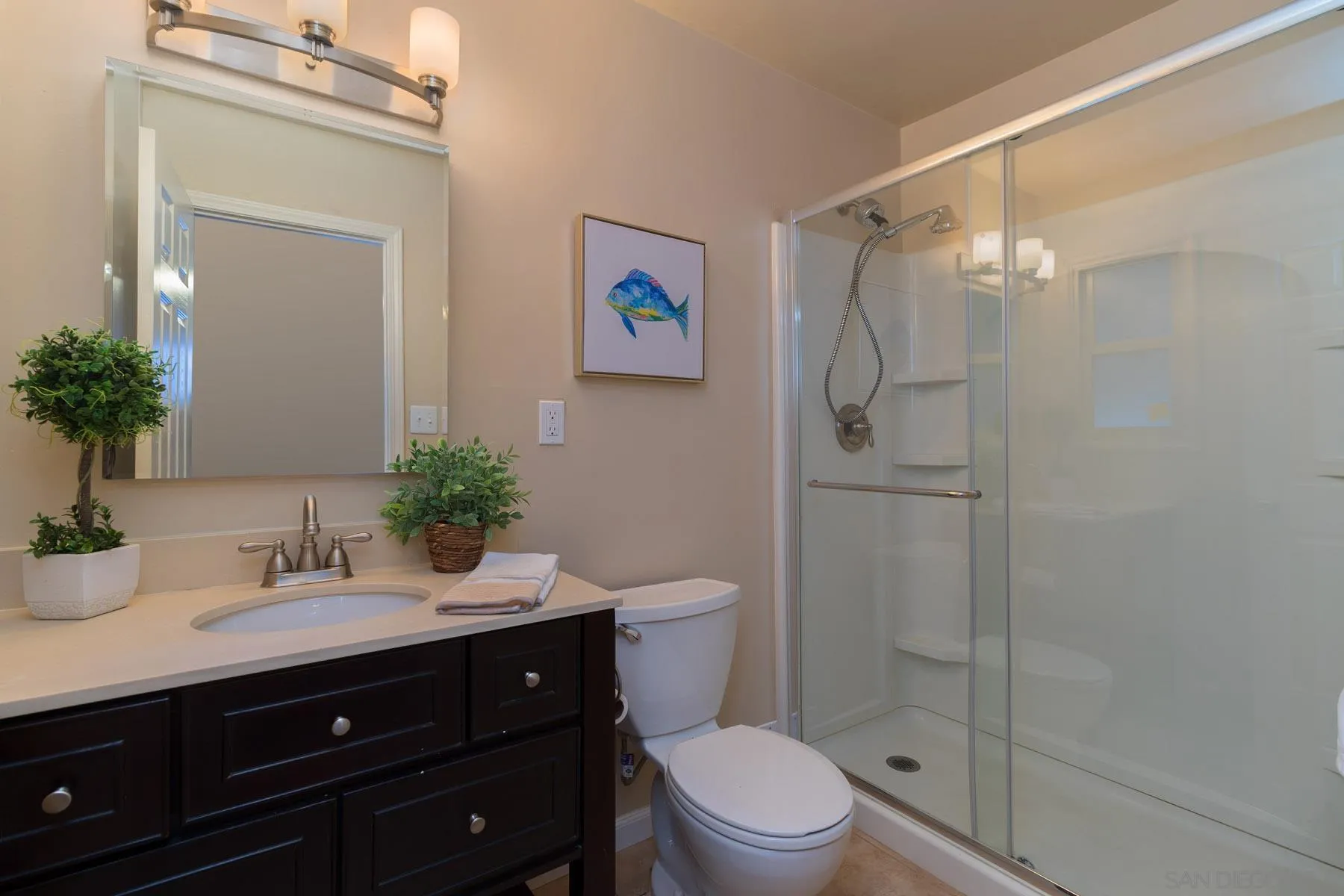 13424 Powers Road Poway, CA 92064 - Photo 14 of 24 a bathroom with a granite countertop sink a toilet a shower and a mirror