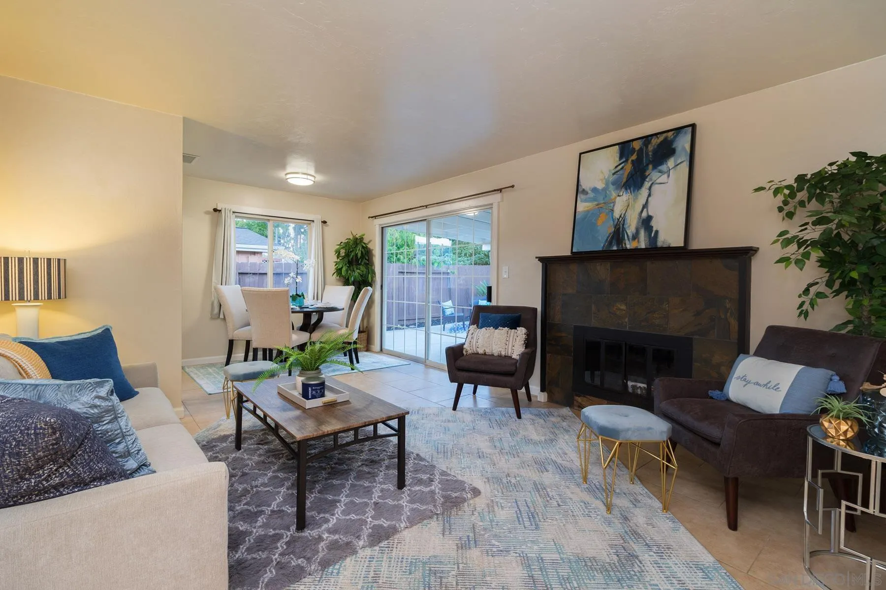 13424 Powers Road Poway, CA 92064 - Photo 2 of 24 a living room with furniture potted plant a fireplace and a large window