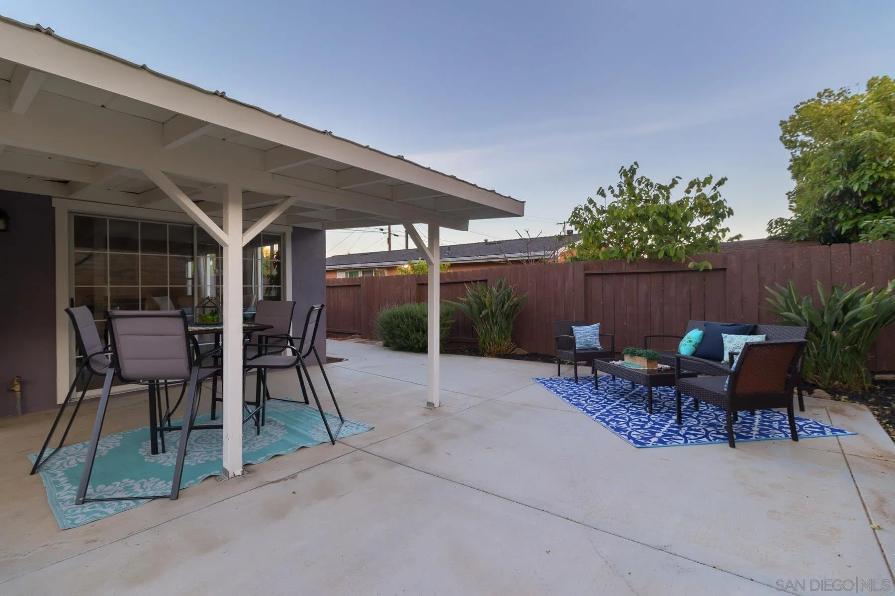 13424 Powers Road Poway, CA 92064 - Photo 24 of 24 a view of a patio with table and chairs potted plants and floor to ceiling window