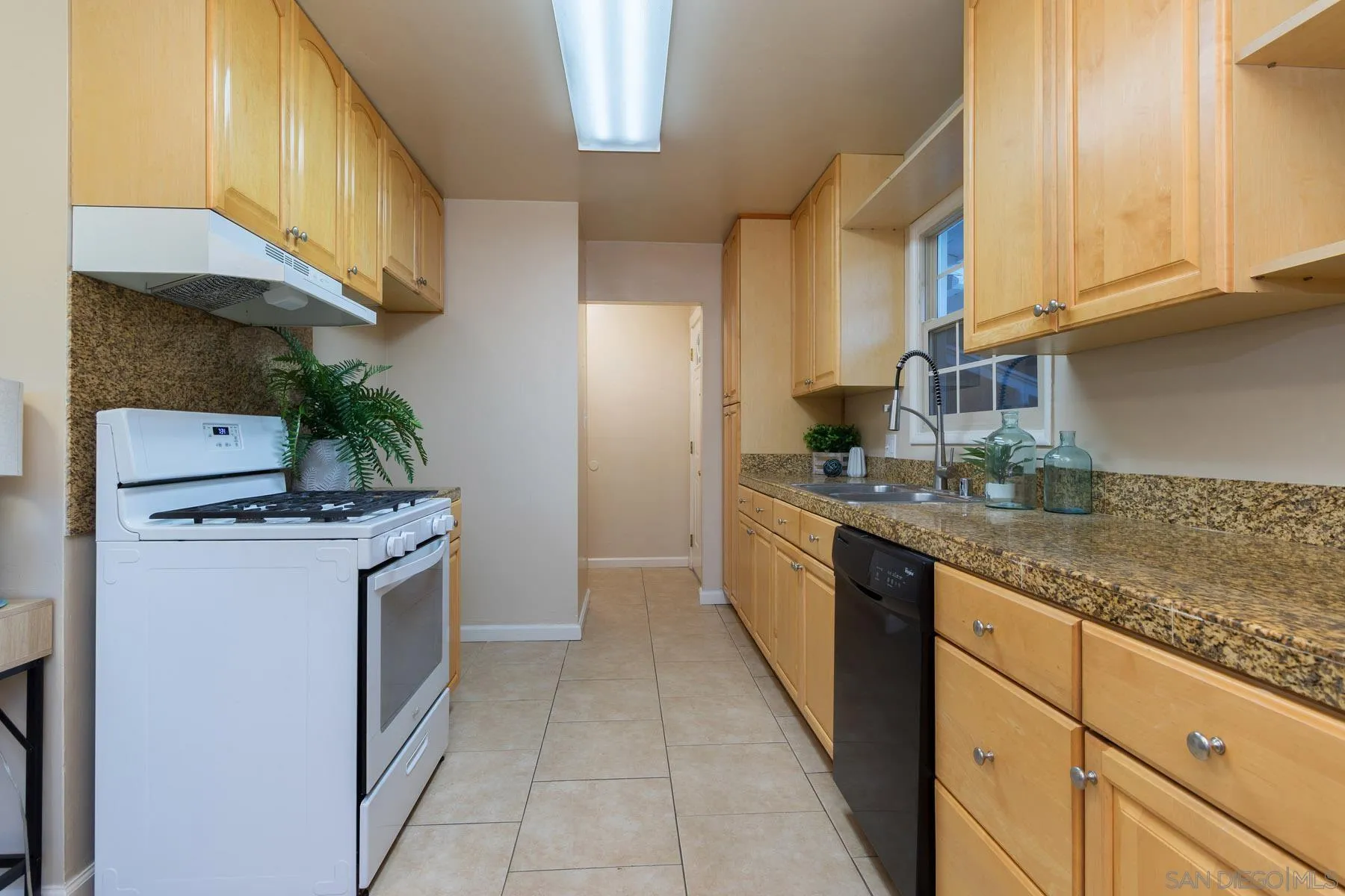 13424 Powers Road Poway, CA 92064 - Photo 8 of 24 a kitchen with stainless steel appliances granite countertop a stove a sink and a refrigerator