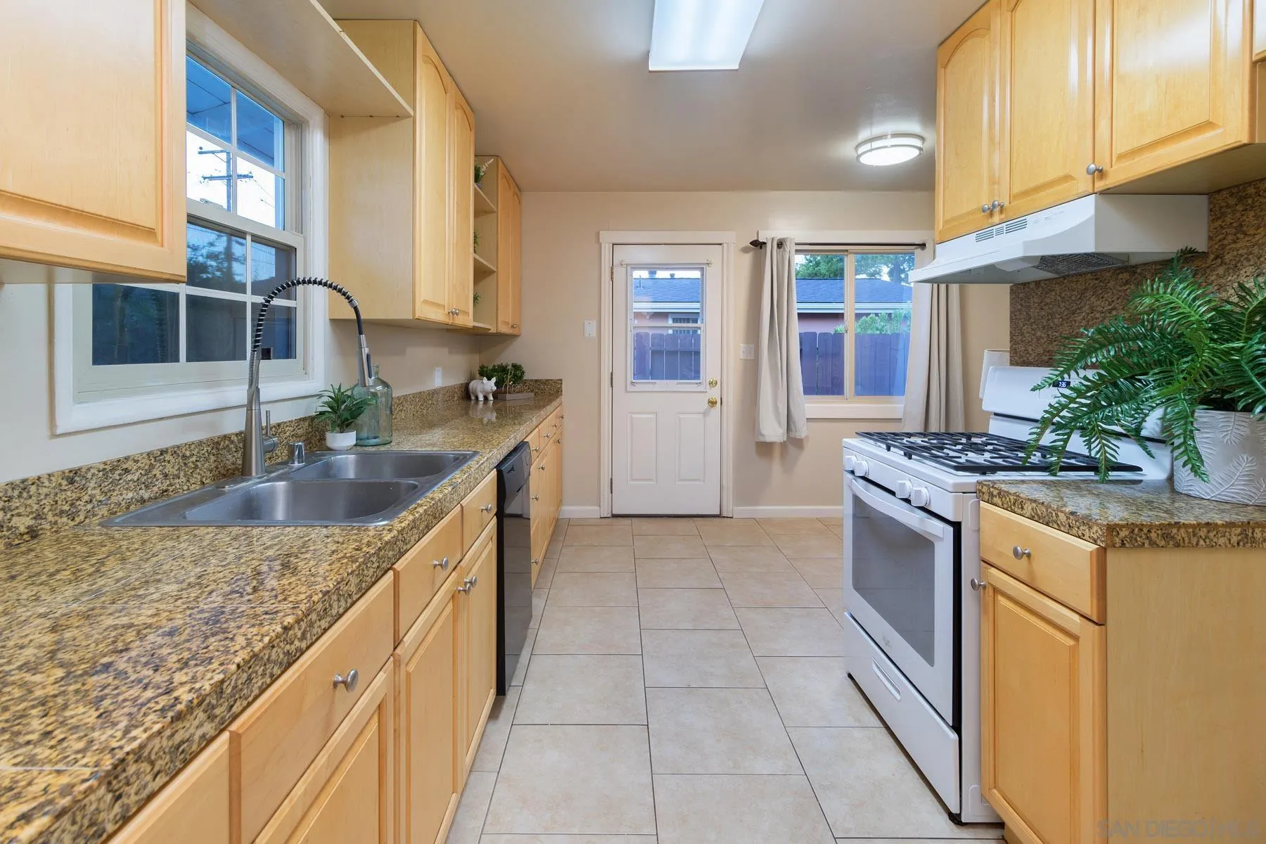 13424 Powers Road Poway, CA 92064 - Photo 9 of 24 a kitchen with stainless steel appliances granite countertop a sink and a stove