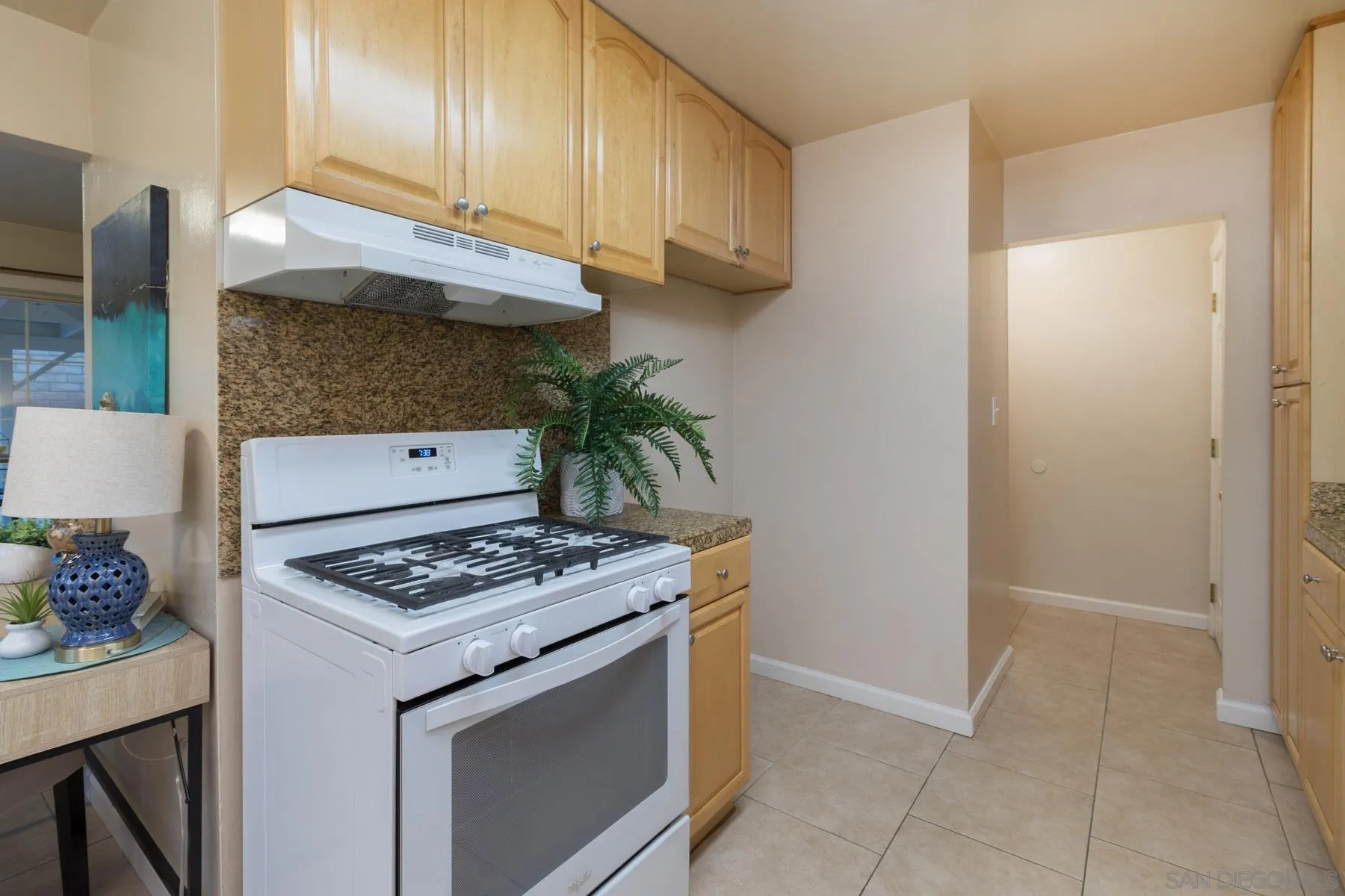 13424 Powers Road Poway, CA 92064 - Photo 10 of 24 a kitchen with granite countertop a sink stove and cabinets