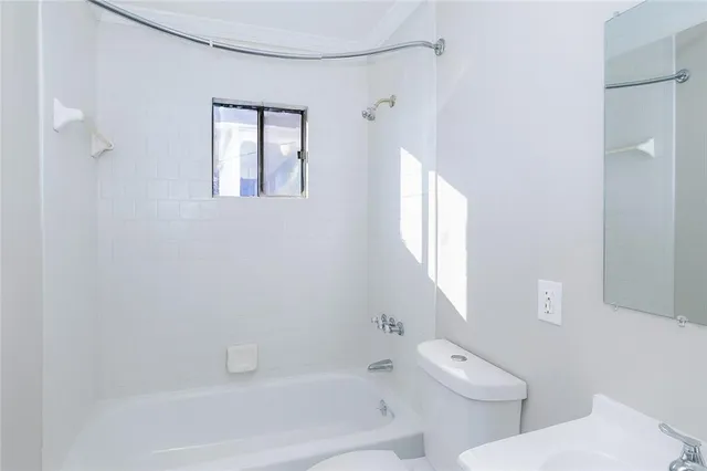 a bathroom with a toilet sink and shower