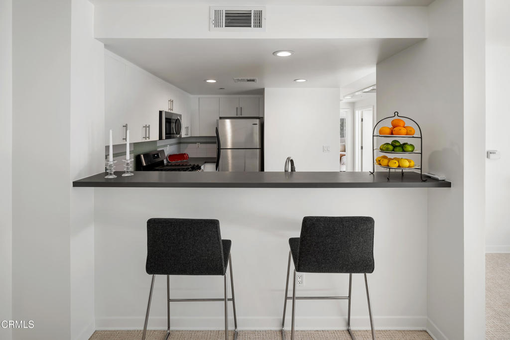 159 West Green Street, Unit 502A Pasadena, CA 91105 - Photo 12 of 40 a close view of table chairs and refrigerator in it