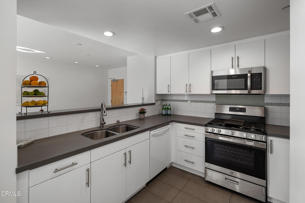 159 West Green Street, Unit 502A Pasadena, CA 91105 - Photo 16 of 50 a kitchen with stainless steel appliances granite countertop a sink and a stove