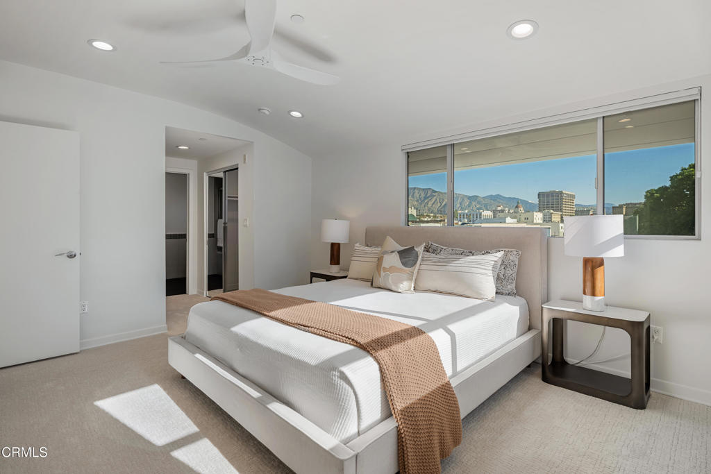 159 West Green Street, Unit 502A Pasadena, CA 91105 - Photo 19 of 40 a bedroom with a large bed and a chandelier