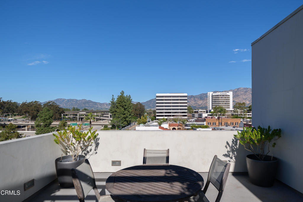 159 West Green Street, Unit 502A Pasadena, CA 91105 - Photo 26 of 40 a roof deck with table and chairs and potted plants