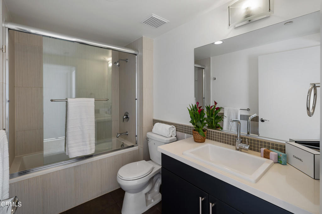 159 West Green Street, Unit 502A Pasadena, CA 91105 - Photo 26 of 50 a bathroom with a sink a toilet a mirror and shower