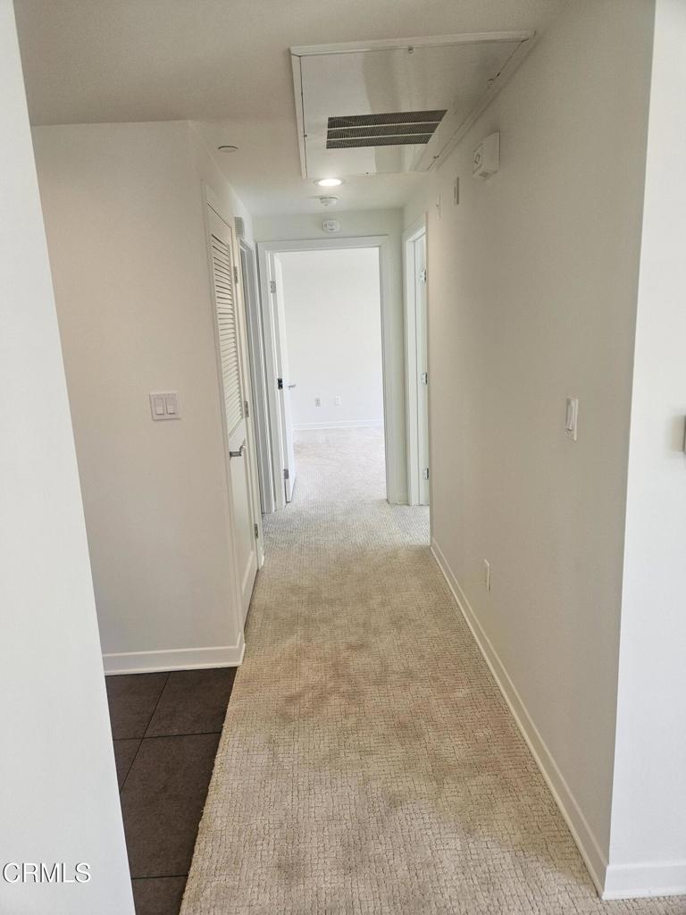 159 West Green Street, Unit 502A Pasadena, CA 91105 - Photo 34 of 40 a view of a hallway with wooden floor and a bathroom