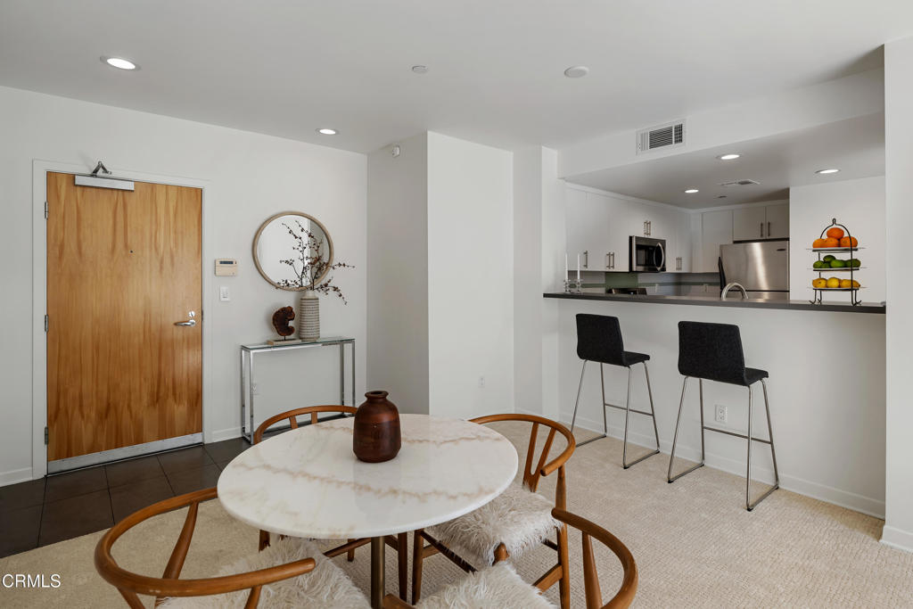 159 West Green Street, Unit 502A Pasadena, CA 91105 - Photo 6 of 40 a kitchen with a table and chairs in it
