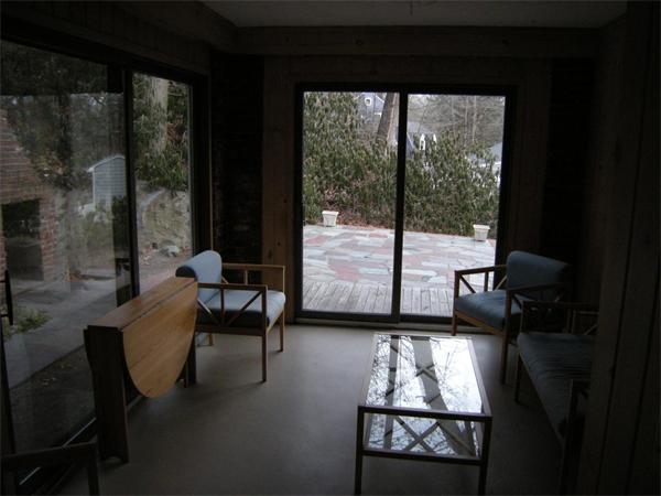 259 Varick Road Newton, MA 02468 - Photo 16 of 28 a living room with furniture and a floor to ceiling window