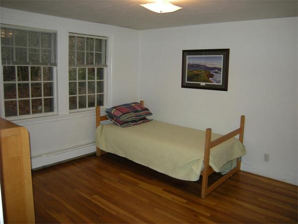 259 Varick Road Newton, MA 02468 - Photo 23 of 28 a bedroom with a bed and wooden floor