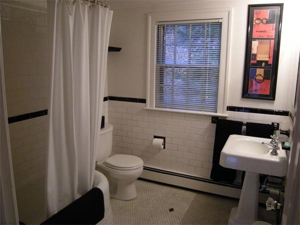 259 Varick Road Newton, MA 02468 - Photo 27 of 28 a bathroom with a toilet a sink and a mirror
