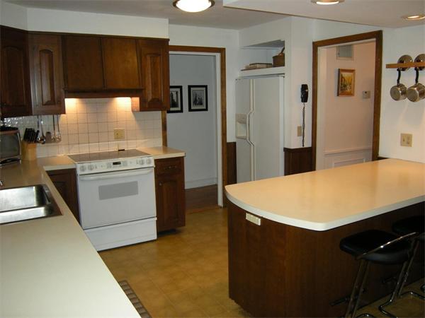 259 Varick Road Newton, MA 02468 - Photo 9 of 28 a kitchen with a stove and a refrigerator