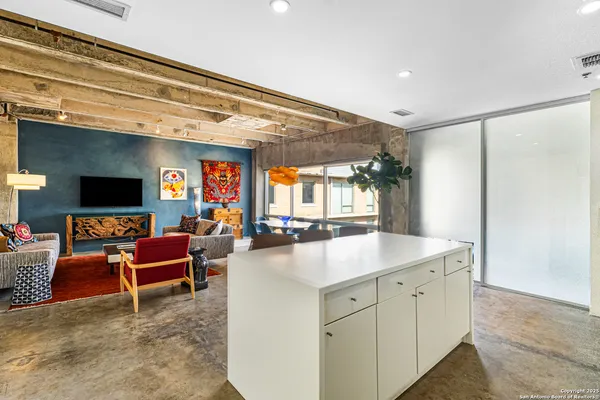 a kitchen with stainless steel appliances granite countertop a sink and a refrigerator