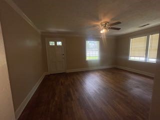 1703 39th Street, Unit A Columbus, GA 31904 - Photo 4 of 12 a view of an empty room with wooden floor and a window