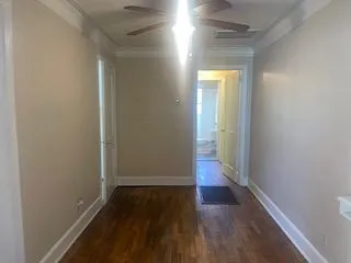 a view of a hallway with wooden floor