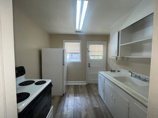 1703 39th Street, Unit A Columbus, GA 31904 - Photo 8 of 12 a kitchen with a sink a stove and refrigerator