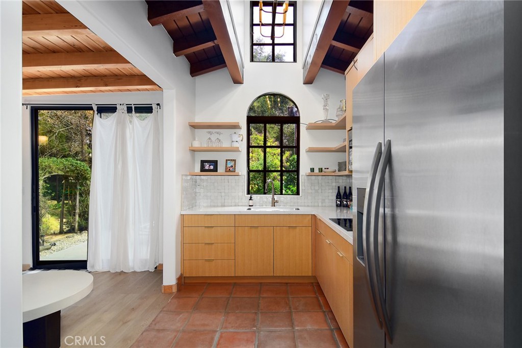 31350 Lobo Canyon Road Agoura Hills, CA 91301 - Photo 18 of 24 a kitchen with stainless steel appliances granite countertop a refrigerator and a sink