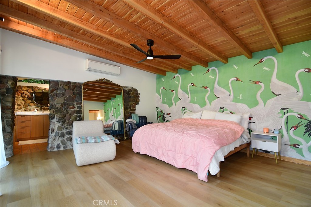 31350 Lobo Canyon Road Agoura Hills, CA 91301 - Photo 20 of 24 a bedroom with a bed and a chandelier