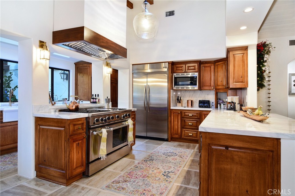 31350 Lobo Canyon Road Agoura Hills, CA 91301 - Photo 4 of 24 a kitchen with stainless steel appliances granite countertop a sink a stove and a refrigerator