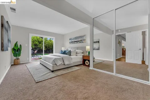 a bedroom with a bed lamp and window