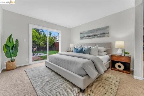 a bedroom with bed and a window