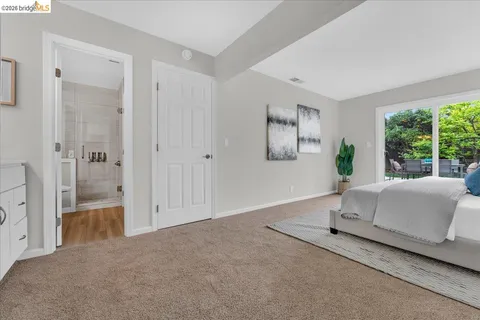 a spacious bedroom with a balcony a bed and a couch