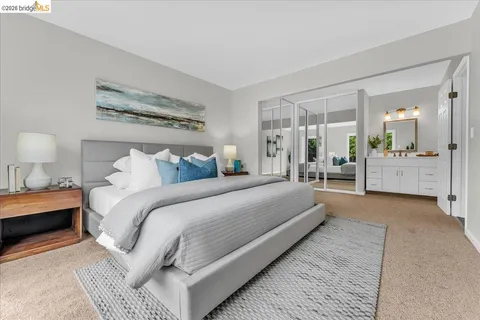 a bedroom with a large bed and a chandelier