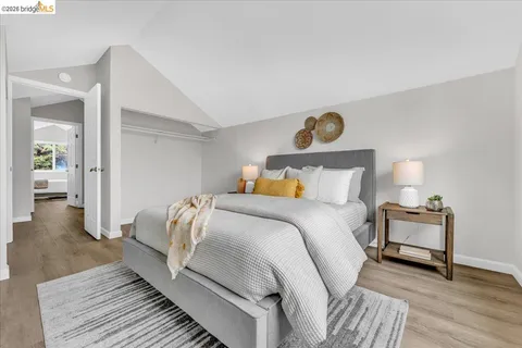 a bedroom with a bed and wooden floor